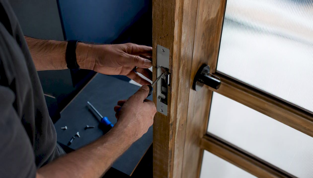 Technician testing latchbolt with no-cut electric strike