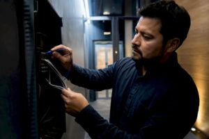 Technician tracing intercom door release wiring
