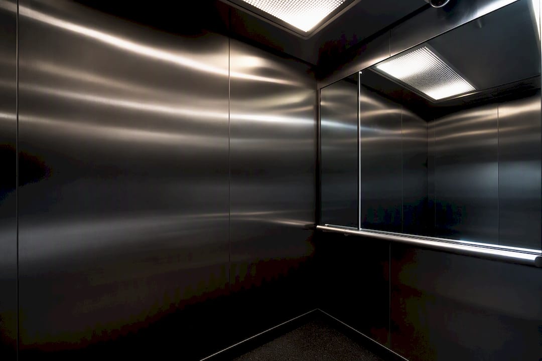 Elevator cab showing harsh overhead lighting