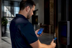 Technician testing intercom access at NYC lobby
